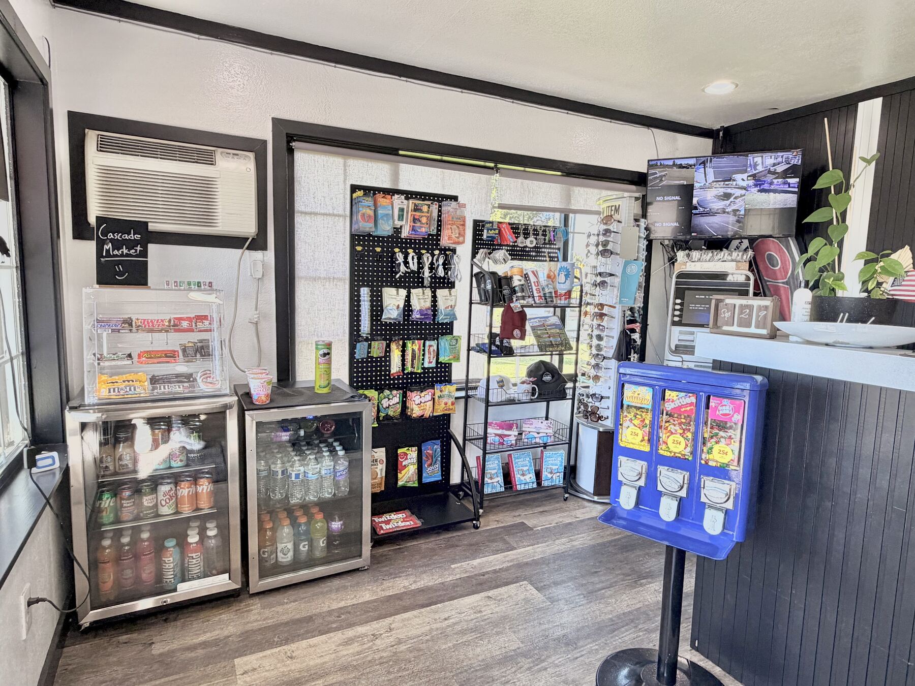 Cascade Market corner in the lobby with drink coolers, snacks, travel essentials, and a gumball machine