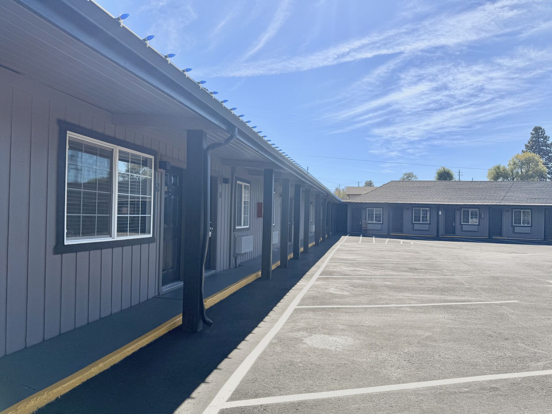 Guest room buildings around the paved courtyard with covered walkways
