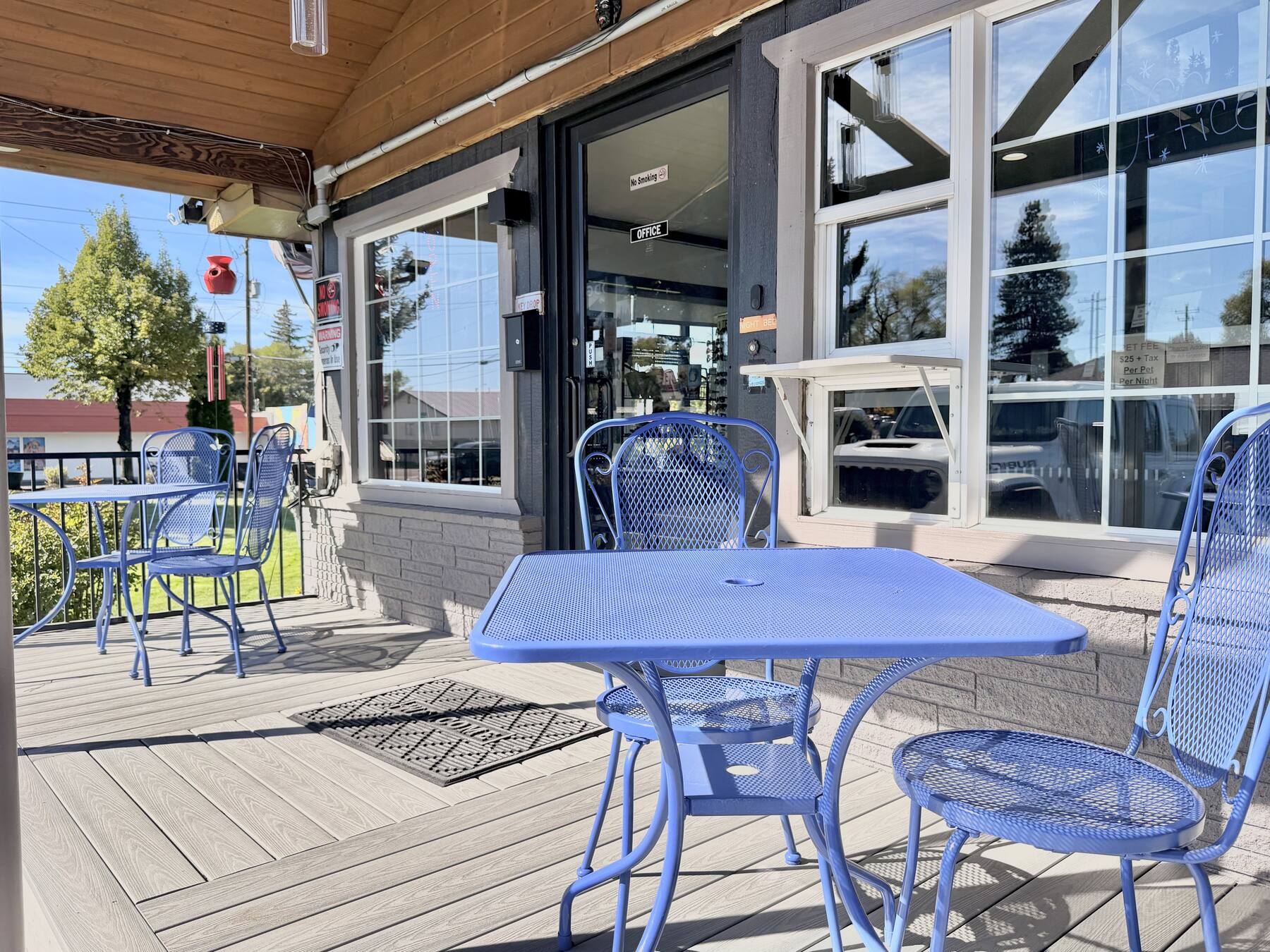 Covered front office patio with blue bistro tables and chairs