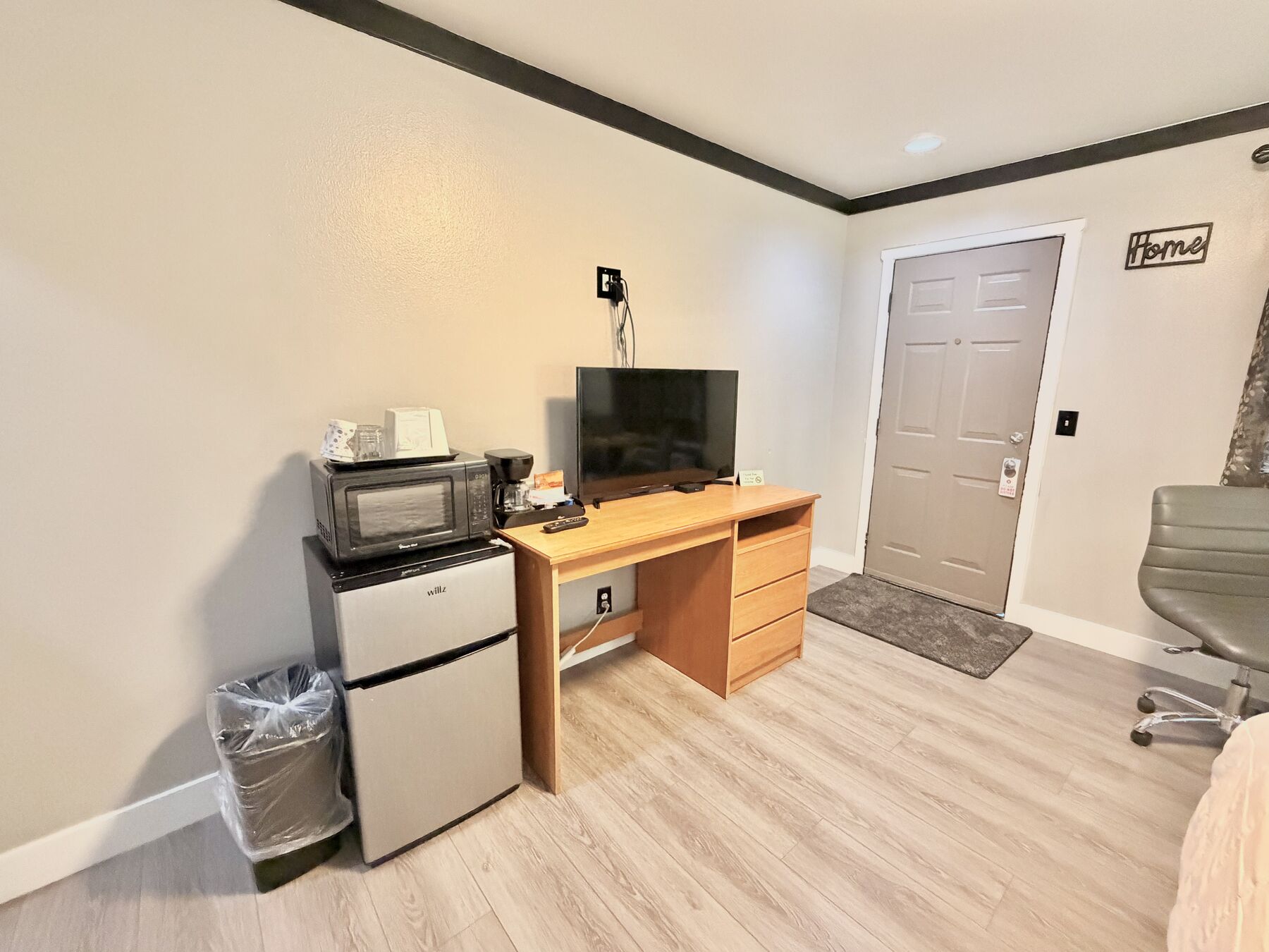 Cascade Queen desk with flat-screen TV, coffee maker, microwave, and mini refrigerator near the room entrance