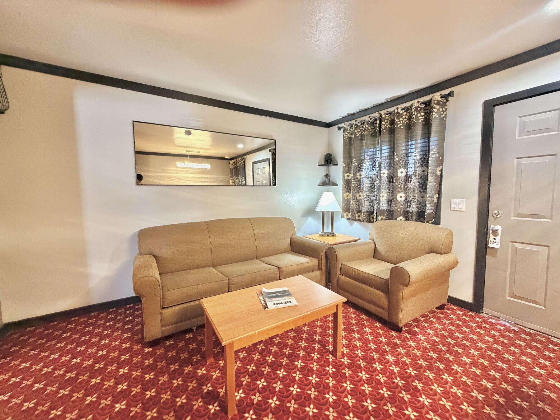 Sisters Queen Spa Suite sitting area with a sofa, armchair, coffee table, and private entry door